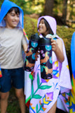 Two children holding colorful water bottles with a blurred natural background