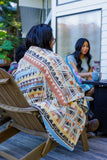 Blanket draped over man's shoulders.