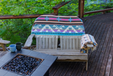 blanket draped on Adirondack chair