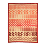 A rectangular woven textile with horizontal geometric patterns in terracotta, coral, peach, and cream, finished with a red border and small woven labels near the bottom corners.
